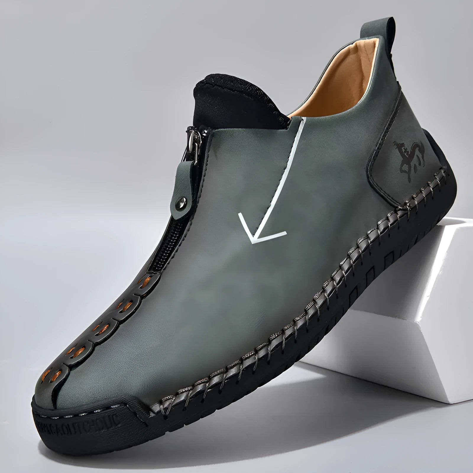 Men's brown leather boots with front zip closure and hand-stitched rubber soles
