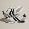 Red and blue low-top lace-up running sneakers on a white background.