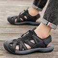 Men's blue mesh velcro sports shoe with rubber sole and toe holder design on a white background