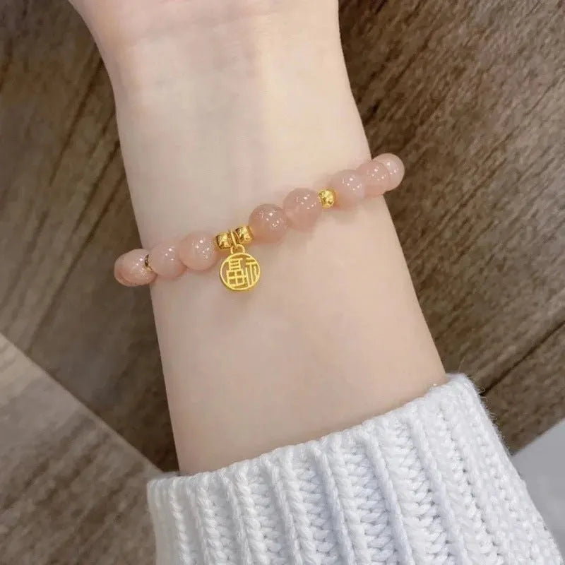 Handmade Chinese style glass bracelet with bamboo joint beads in a red Lvzhu Duobao design.