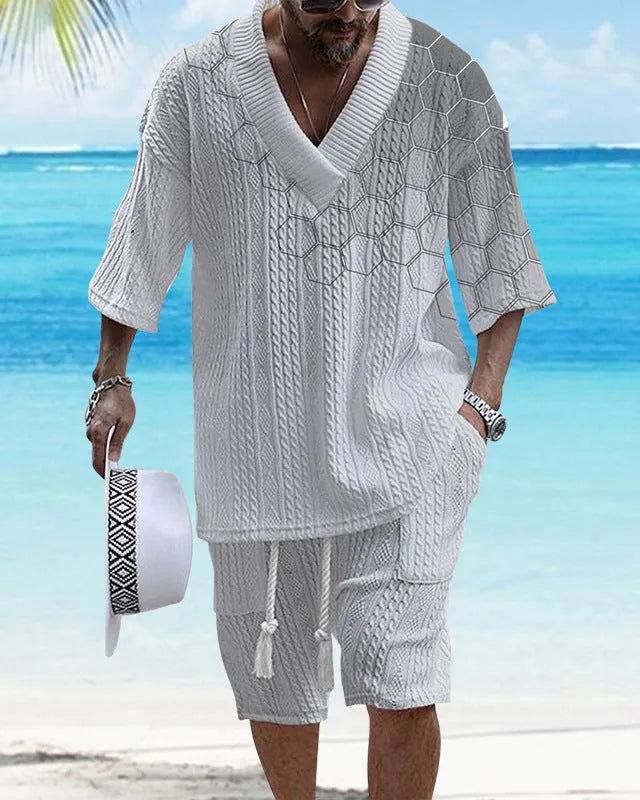 A man wearing a printed drop-shoulder knitted short-sleeved top with matching shorts in a casual setting.