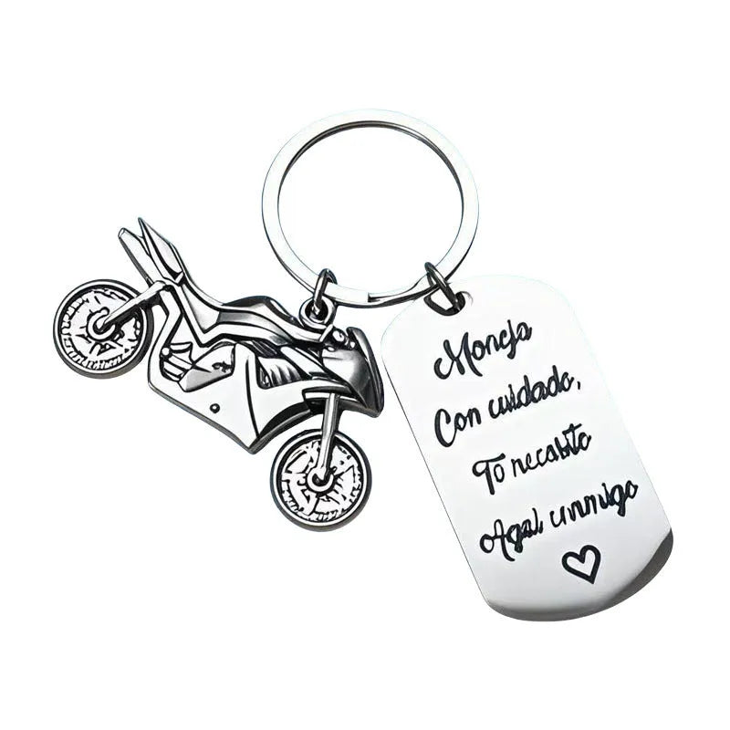 Stainless steel key ring with detailed motorcycle design on metal surface