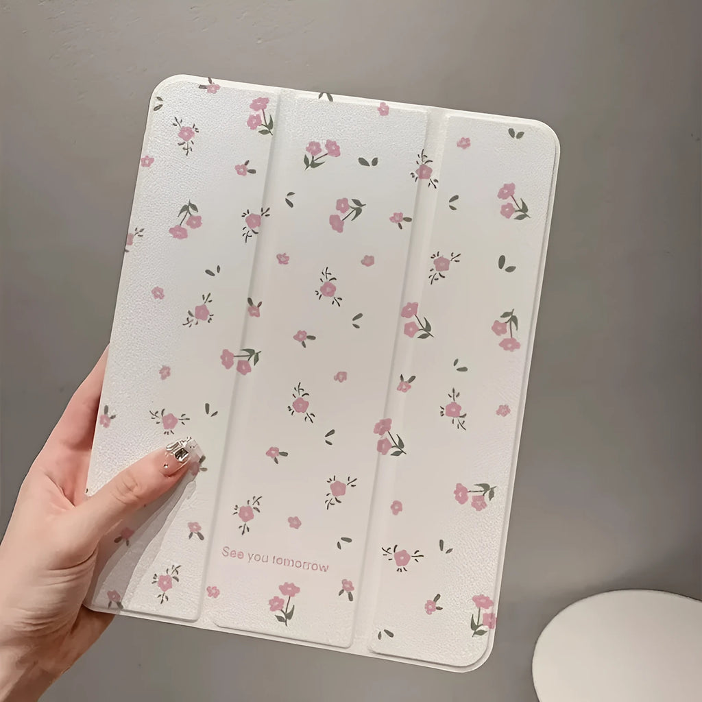 Transparent tri-fold iPad case with floral cartoon pattern, shown in standing position with magnetic closure