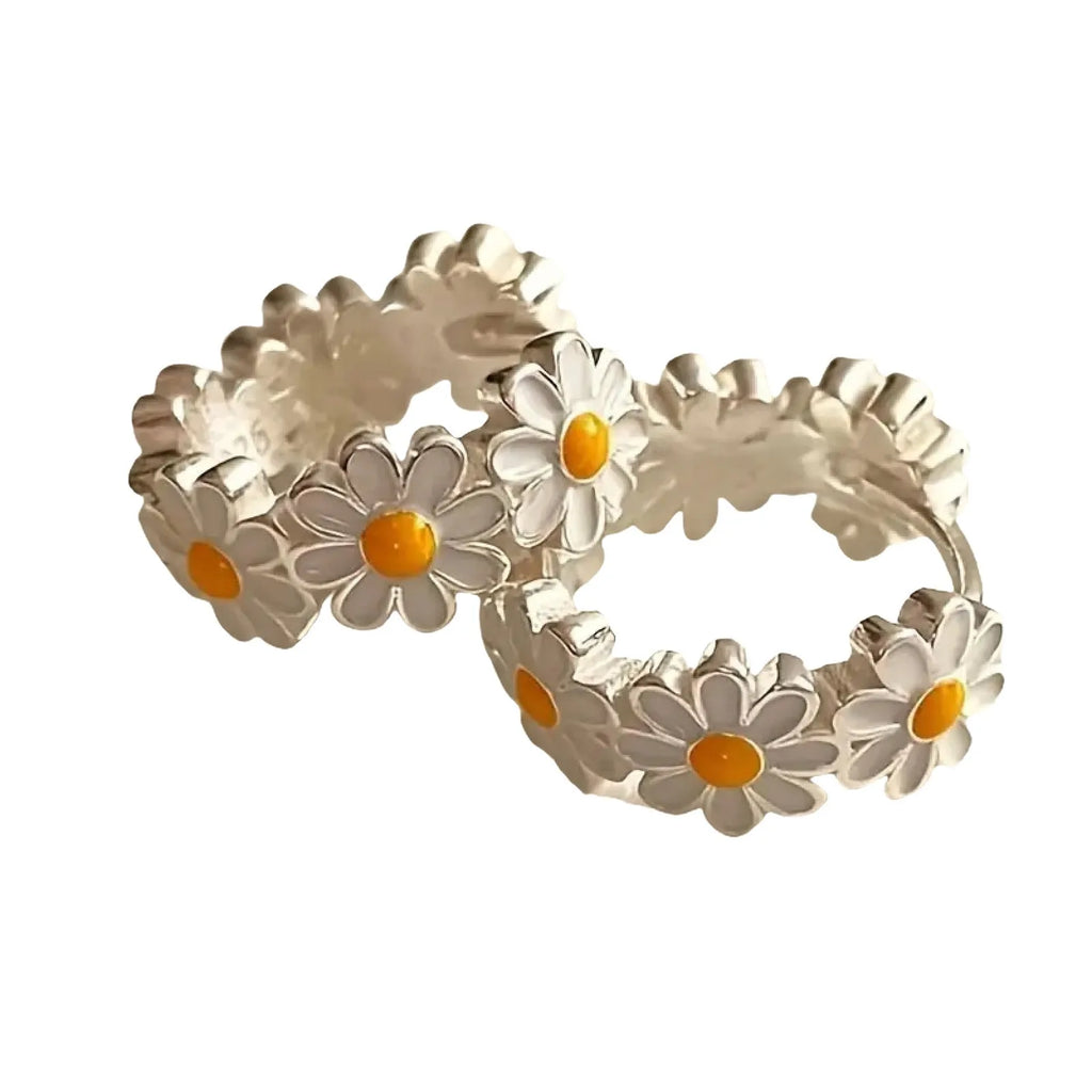 White platinum-electroplated daisy flower ring earrings with gemstone details on a copper base.