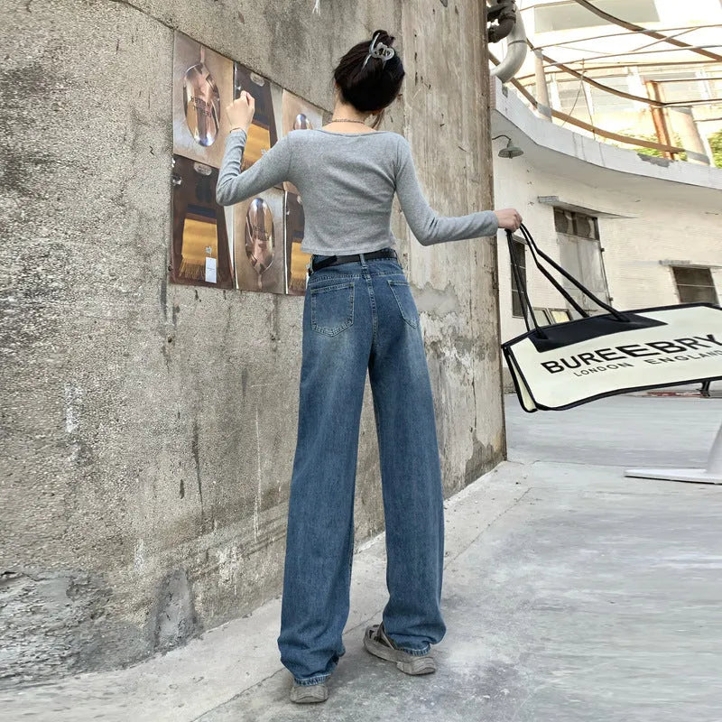 Women's retro blue high-waisted straight-leg jeans on a hanger, showing front detail.