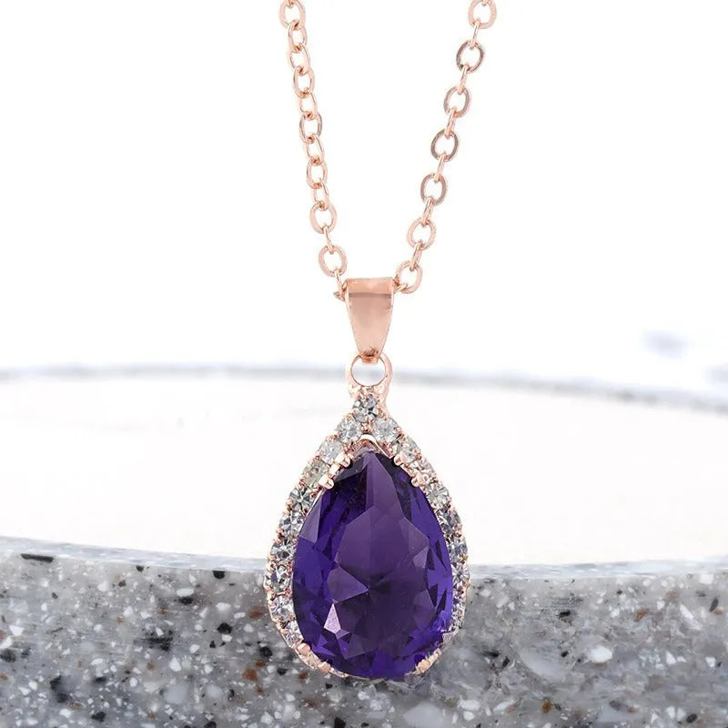 Rose gold water drop shape necklace with rhinestone geometric detailing in pink colour