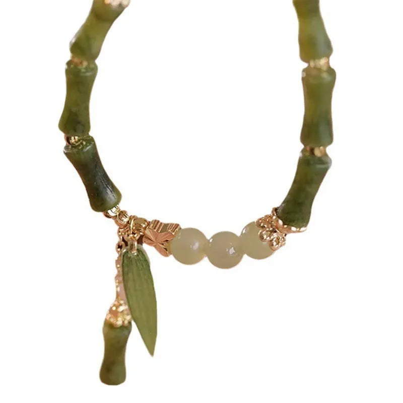 Handmade Chinese style glass bracelet with bamboo joint beads in a red Lvzhu Duobao design.