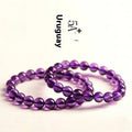 Natural amethyst Uruguay bracelet with scattered beads in various sizes on a wrist.