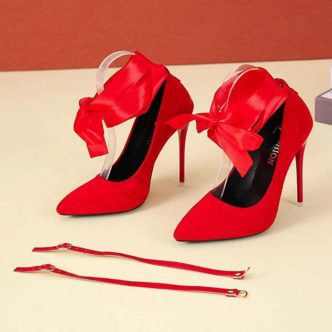 Women's black pointed toe high heel pump with a thin shallow mouth and a lace ankle strap