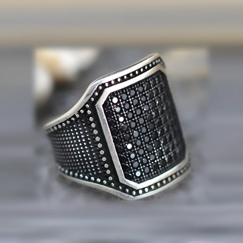 Black alloy ring with copper inlay and zircon stones showing gothic design details