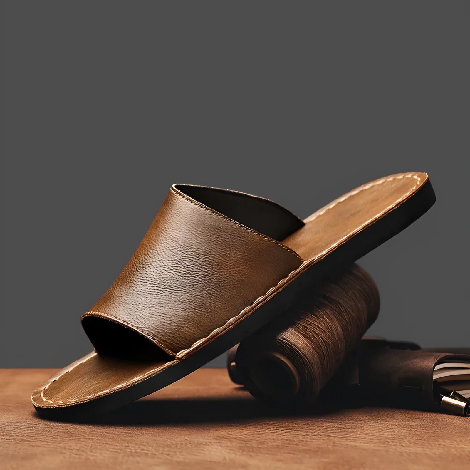 Men's brown leather sandals with adjustable straps and a flat rubber sole on a plain background.