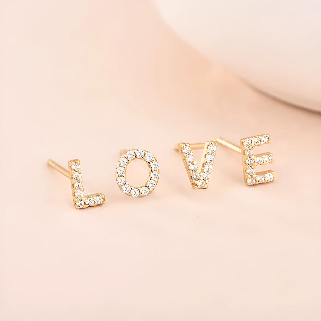 Gold plated alphabet letter earrings with zircon details showing English character design