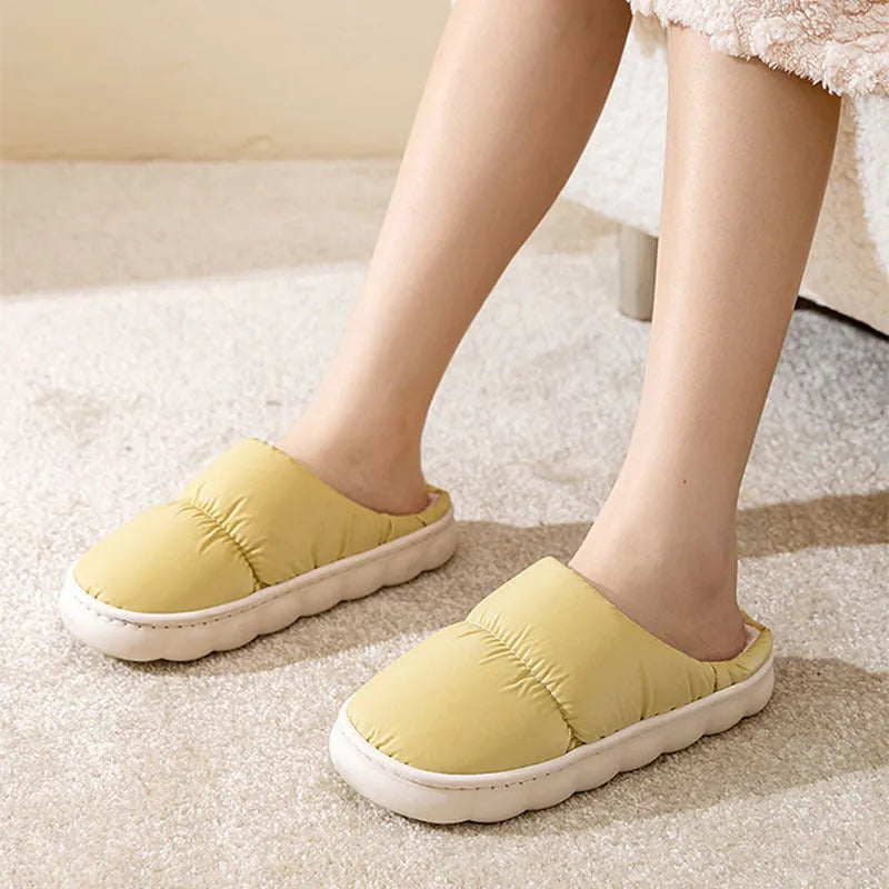 Pair of thick-soled winter slippers with artificial leather upper and plush lining, shown in a choice of colours.