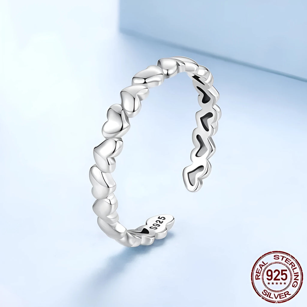 925 sterling silver open heart ring on white background with adjustable band and polished finish