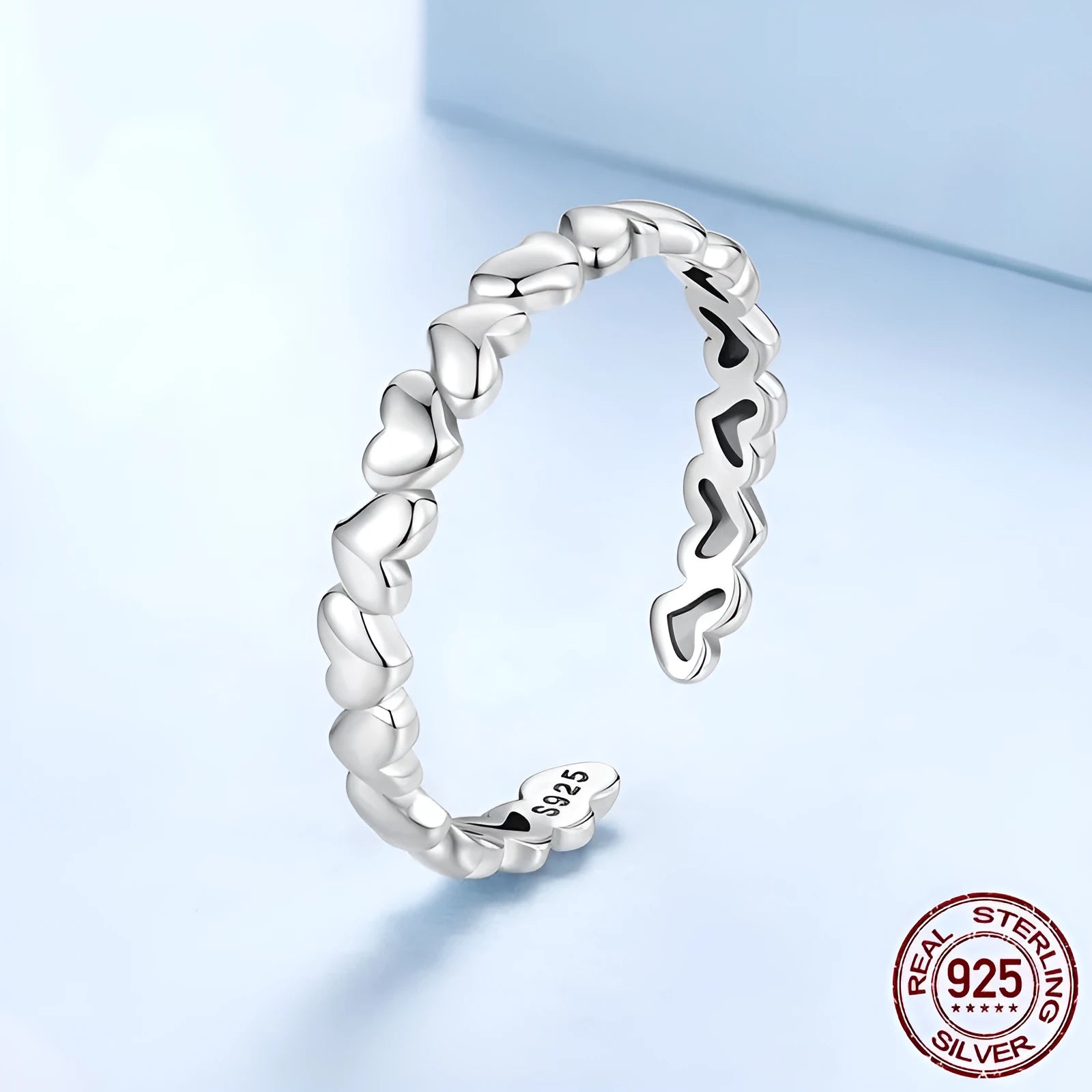 925 sterling silver open heart ring on white background with adjustable band and polished finish