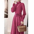 A rose red turtleneck knit dress with long sleeves, an elastic waist, and a loose mid-length skirt.