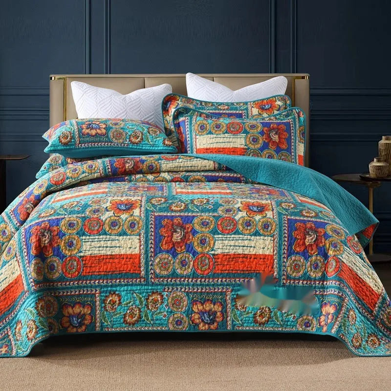 Quilted pure cotton bed cover set with printed pattern on a bed, includes two matching pillowcases.