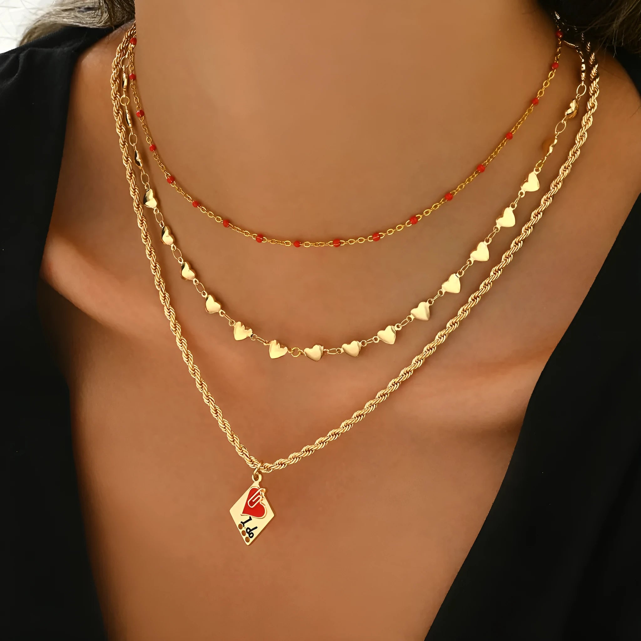 Geometric three-layer heart pendant necklace on a model, showing adjustable clavicle chain length.