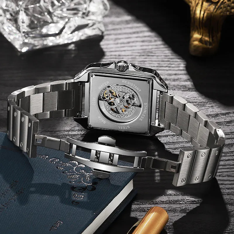 Men's square automatic watch with a diamond-studded dial on a black steel bracelet.