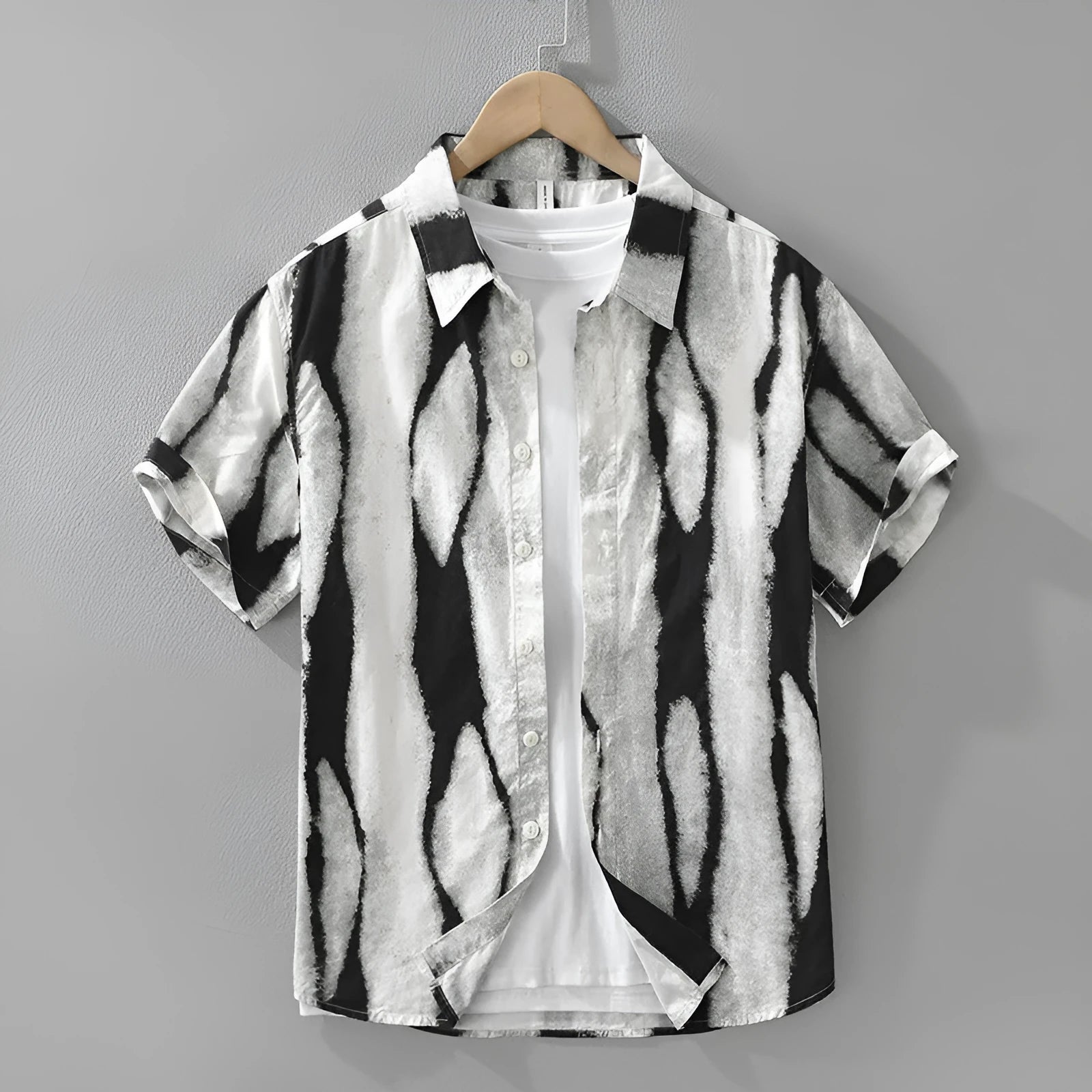 Man wearing a black and white striped pure cotton short sleeve shirt with a loose cardigan fit.