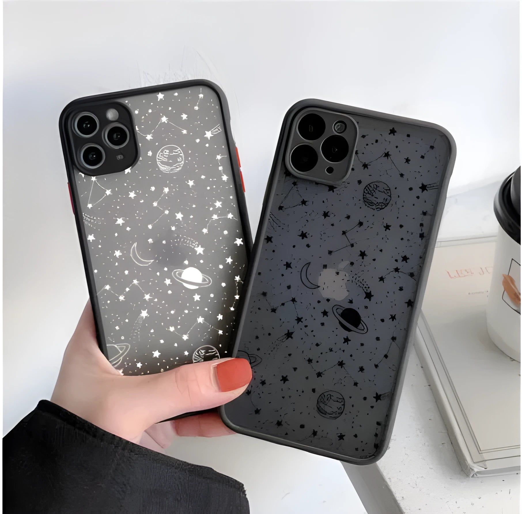 Black and white Star Universe anti-blue light phone case for iPhone models on a table.