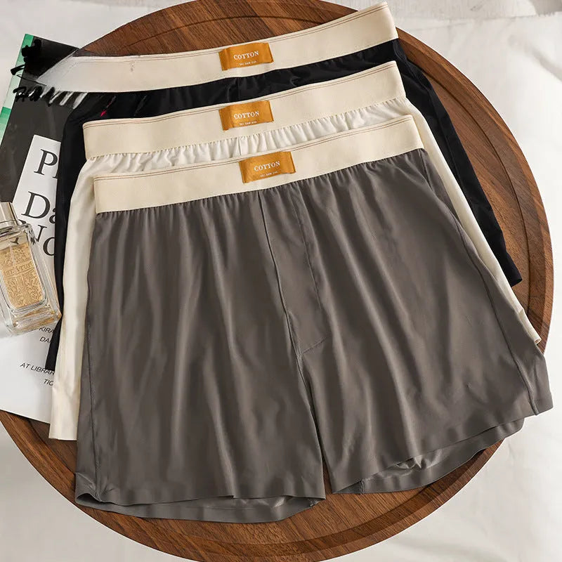 Men's loose fit ice silk underwear in solid colours showing mid-waist design and breathable fabric texture.
