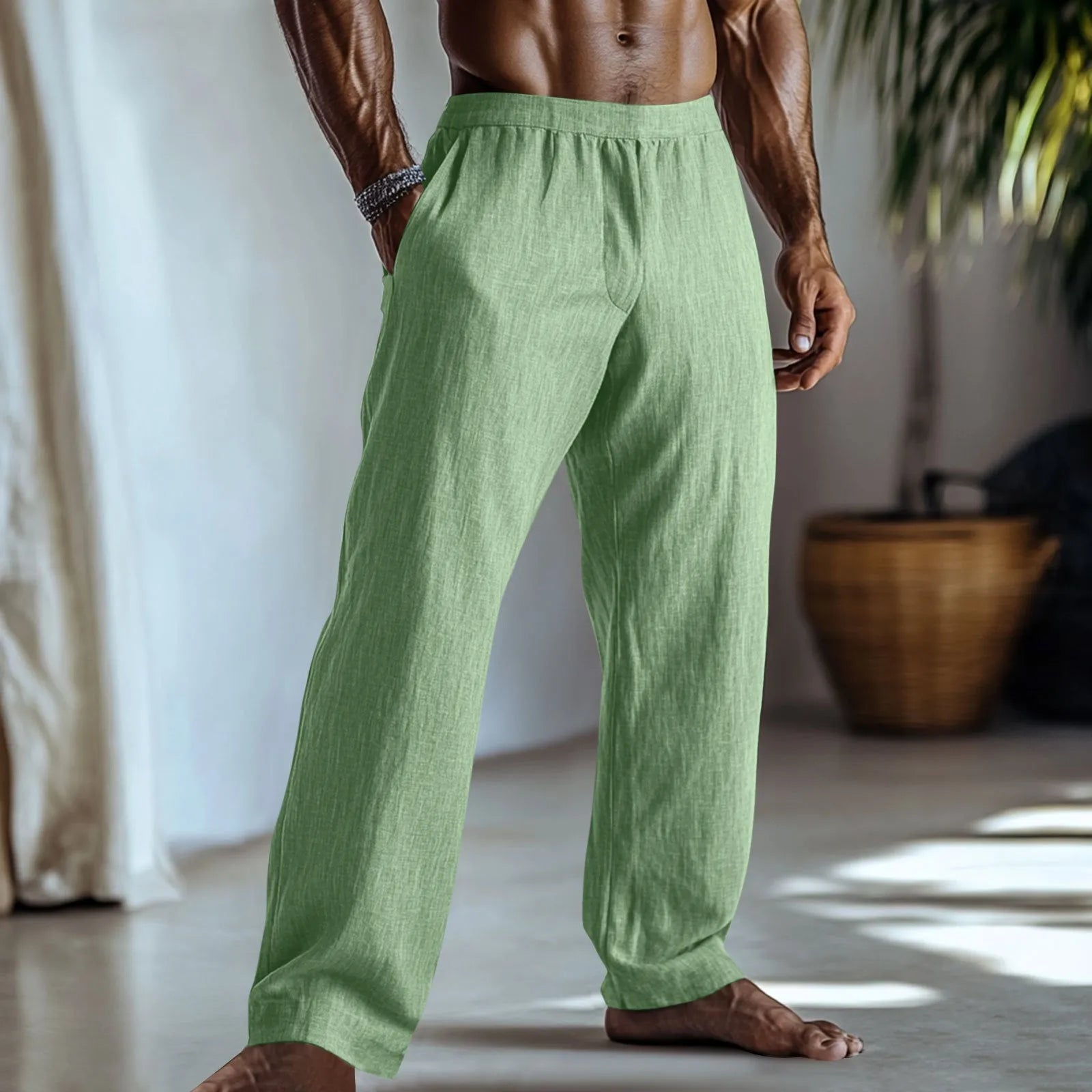Straight leg cotton linen trousers in light green colour with visible front pockets on a plain background