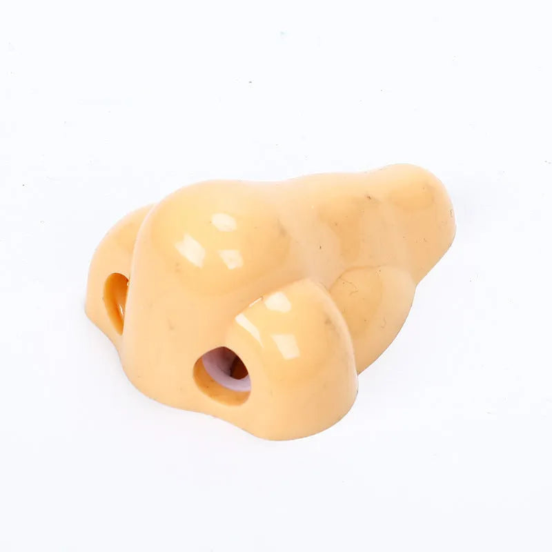 Flesh-coloured geometry-shaped pencil sharpener with big nostril design measuring 58x45x30mm