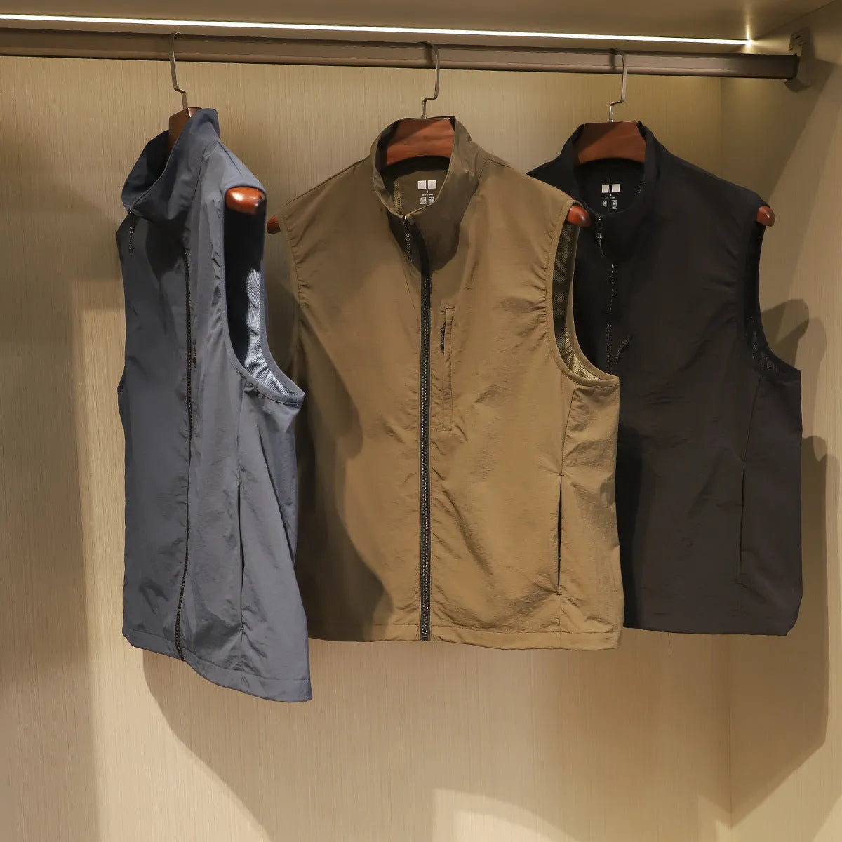 Men's thin nylon vest in straight cut with side pockets, shown in Army Green colour.
