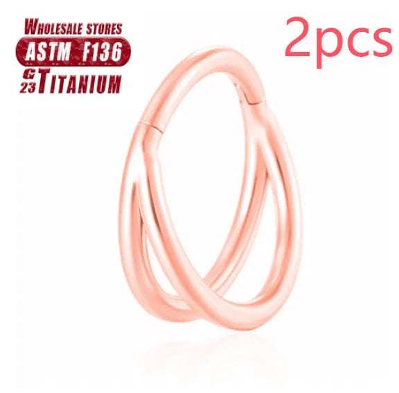 Titanium alloy nose ring on a plain background, shown in silver and gold finishes.