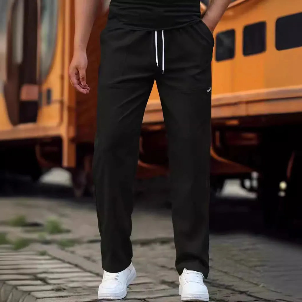 Men's polyester trousers for spring and autumn in light grey, shown flat.