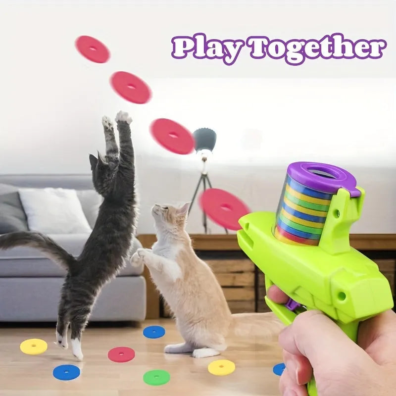 Green or purple plastic cat toy launcher with soft foam discs for interactive play.