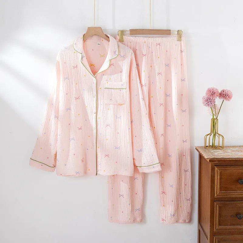 Beige and pink women's long-sleeved cotton pajama set with trousers on a hanger.