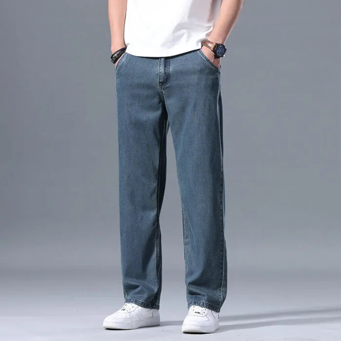 Man wearing light blue loose straight-leg lyocell blend casual jeans.