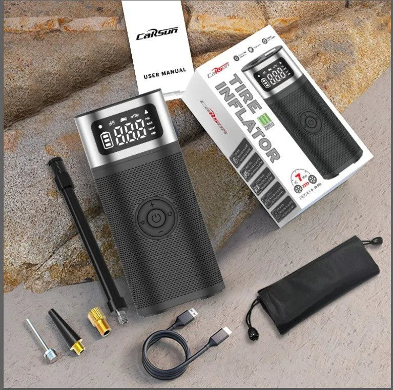 Black portable wireless smart air pump with USB cable, 15cm tube, and nozzle accessories on a grey background.