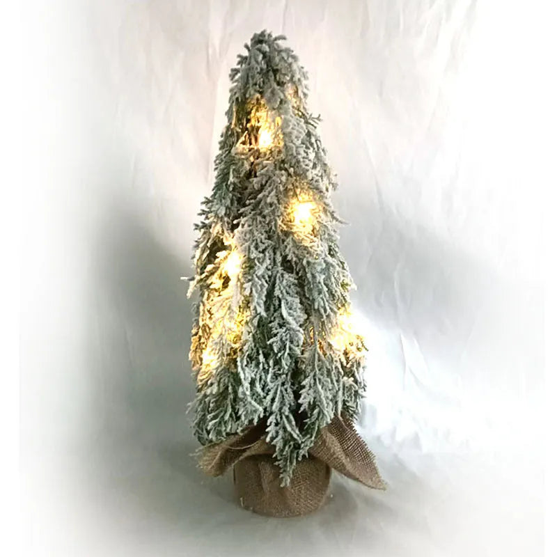 24 inch plastic Christmas tree with lights and PE snow decoration on desktop