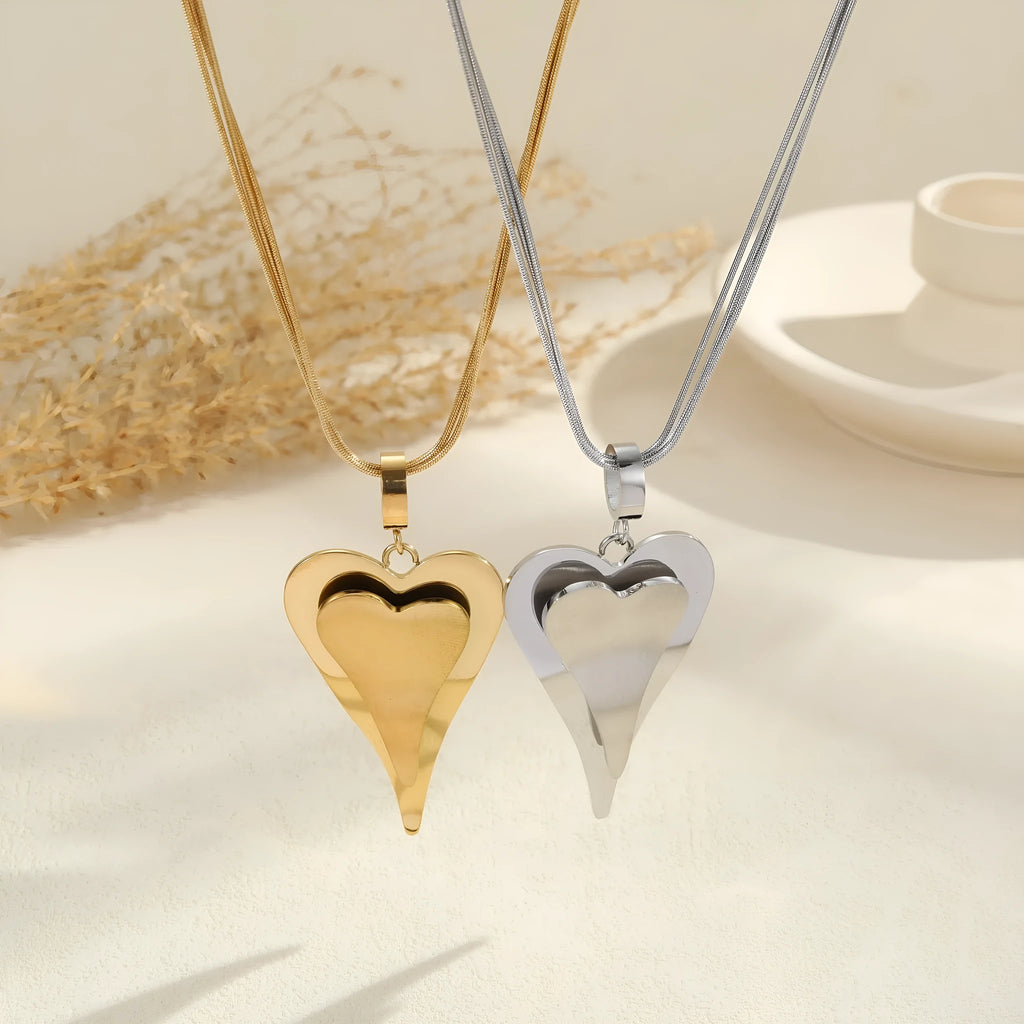 Stainless steel necklace with geometric double heart design formed from snake bones chain elements
