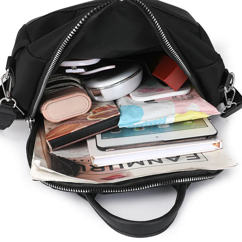 Large soft PU backpack in black with multiple pockets and internal mobile phone storage