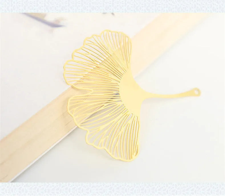 Brass metal bookmark with hollow leaf pattern design and rose gold tassel