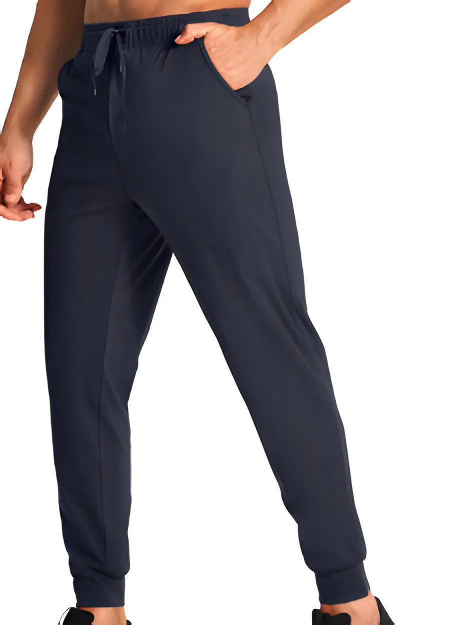 Men's loose-fitting casual polyester trousers in a solid colour on a hanger.