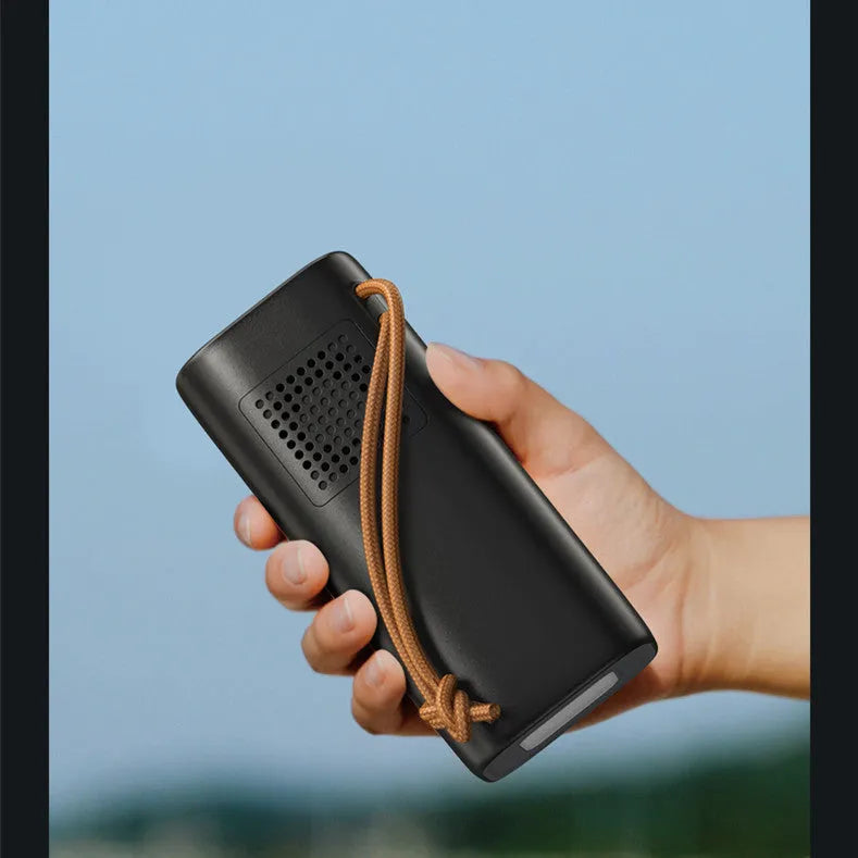 Black portable power bank with solar panel and multiple charging ports for outdoor emergency use