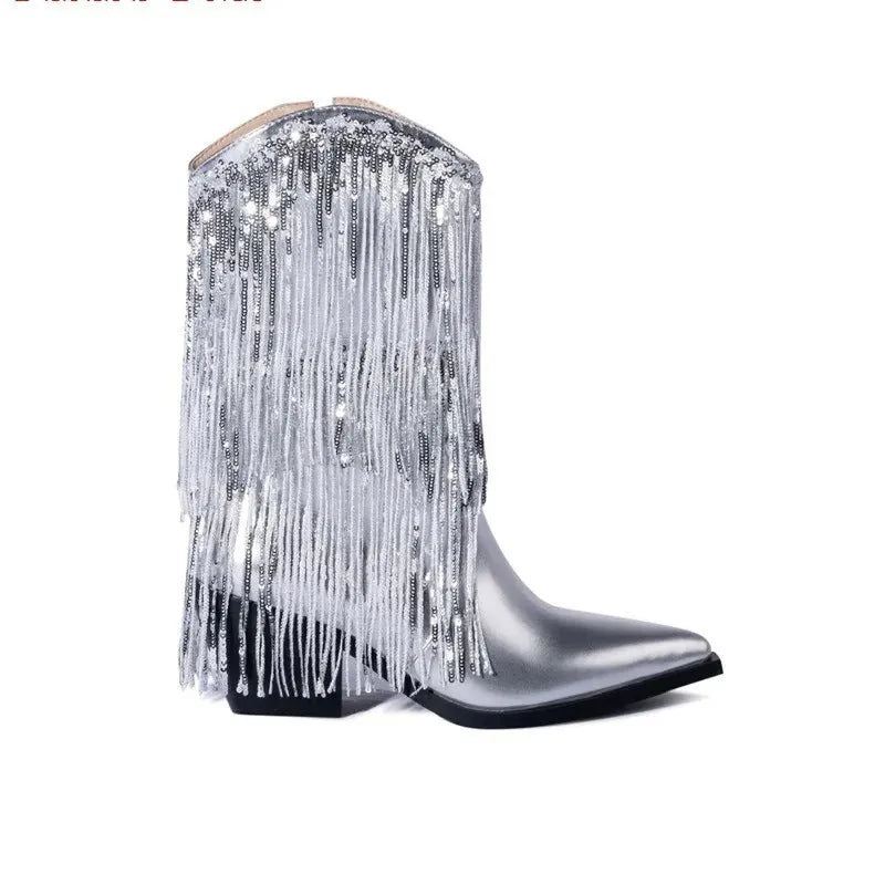 Women's black chunky heel tassel boots with a pointed toe and a high stiletto heel on a fashion runway.