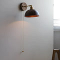 Nordic style wooden wall lamp with walnut finish mounted beside a bed