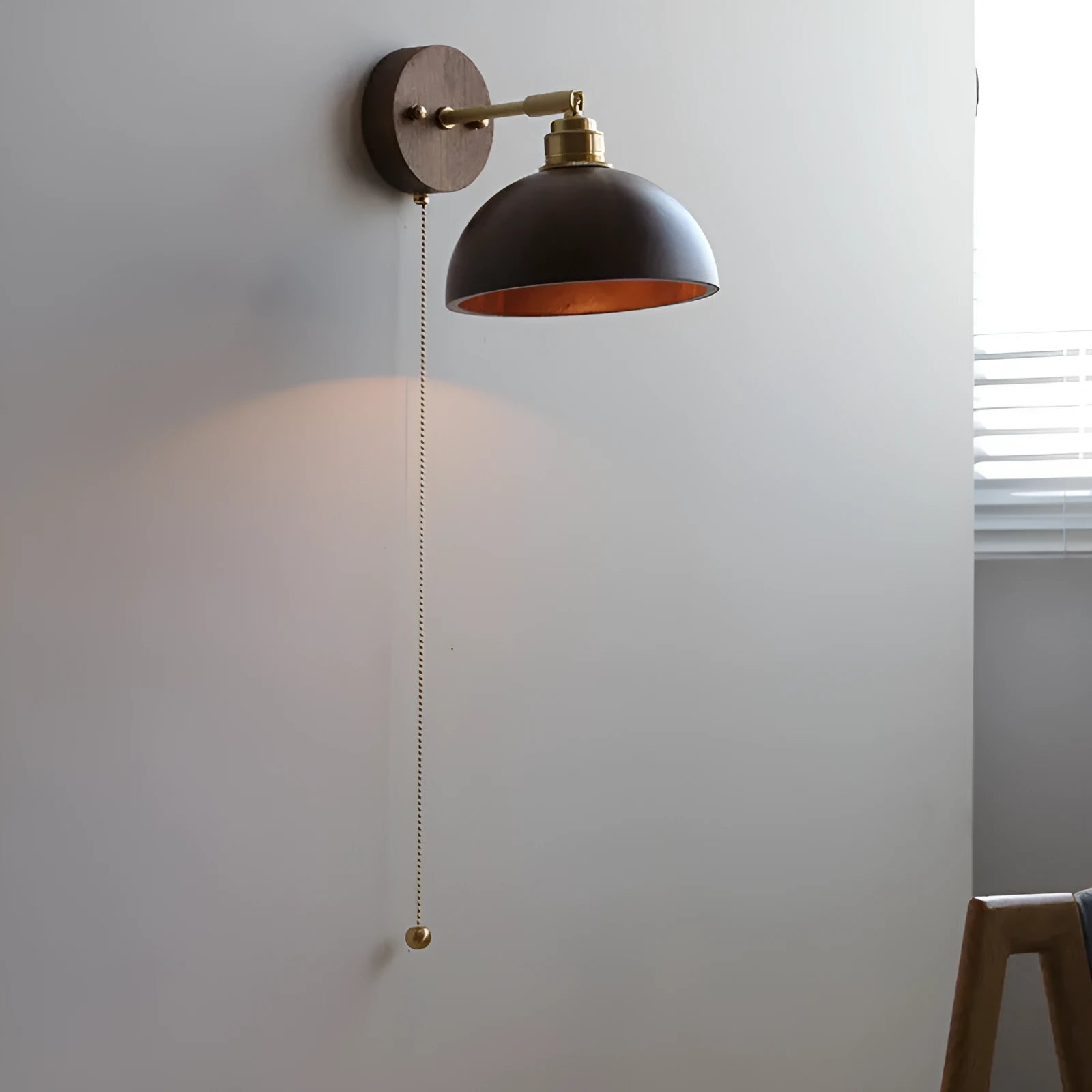 Nordic style wooden wall lamp with walnut finish mounted beside a bed