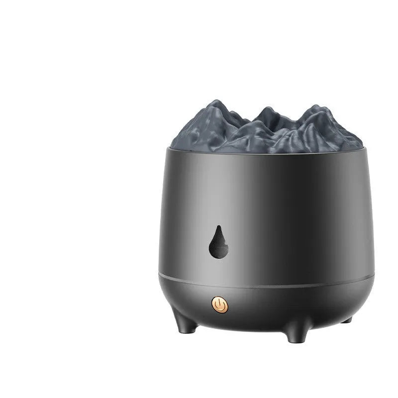 Black and white volcano-shaped ultrasonic humidifier with USB cable on a desk.