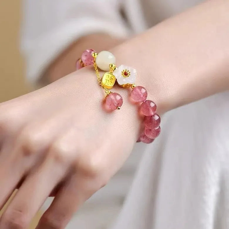 Handmade natural strawberry quartz crystal bracelet for women with moon and pearl bead designs.