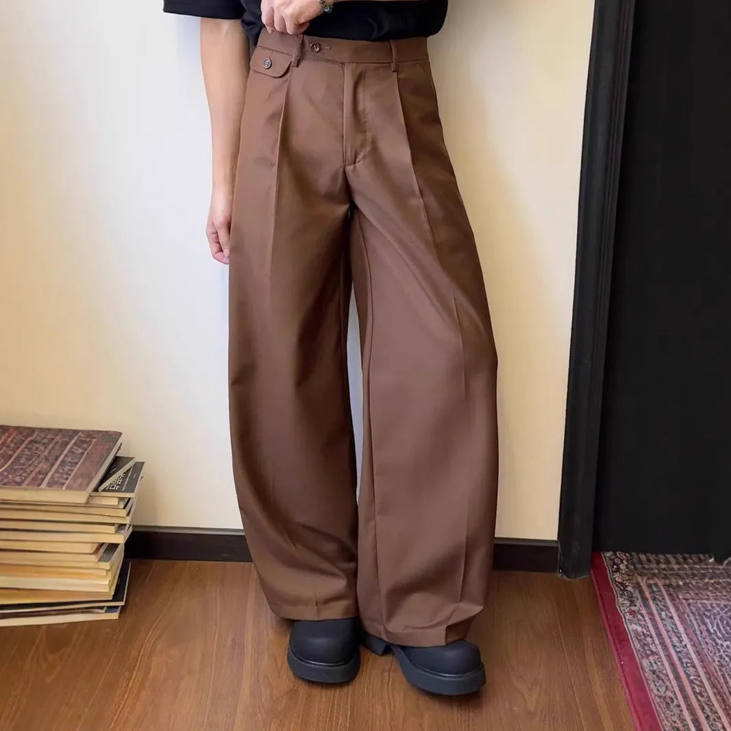Man wearing straight-leg loose fit casual trousers in brown, showcasing the drape and fit.