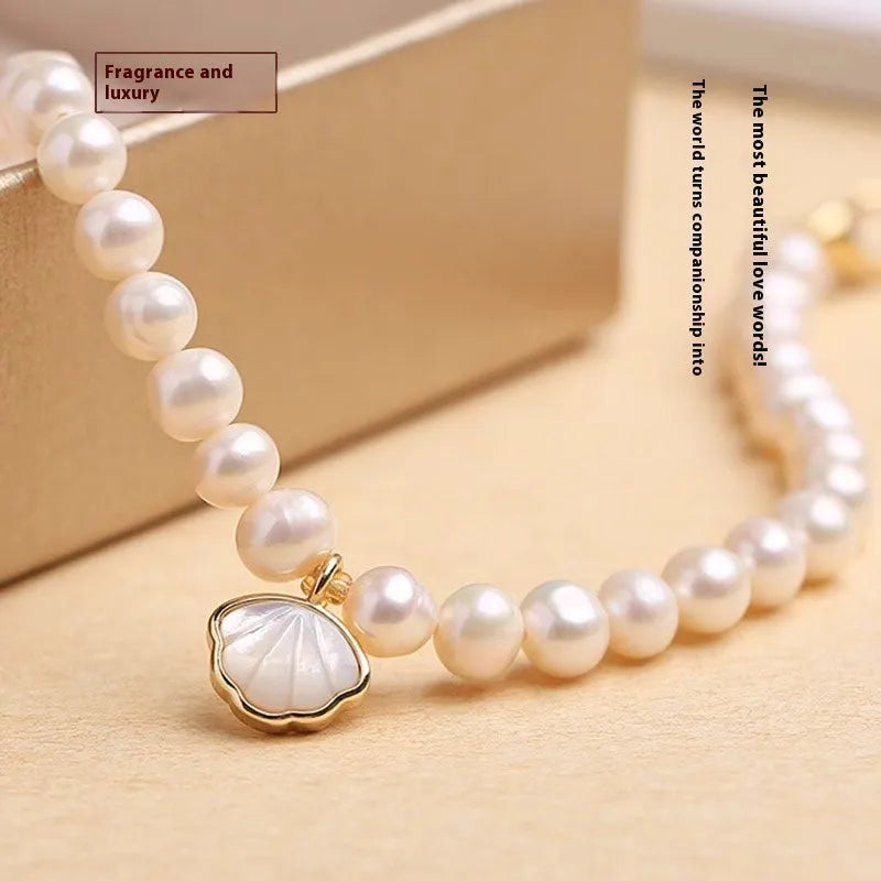 Women's freshwater pearl bracelet with fan design on a 16cm band, showing elastic string and extension chain options.