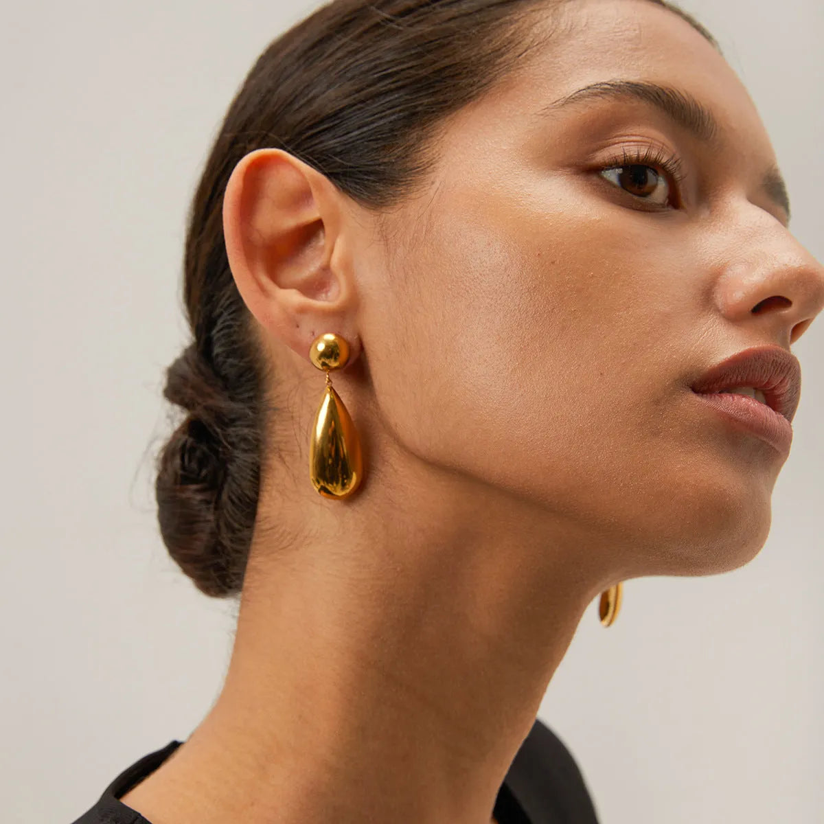 Gold stainless steel water drop pendant earrings with geometric hemisphere design