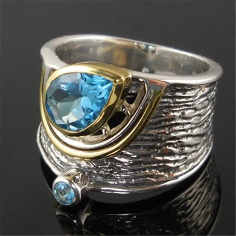 Blue Chinese style alloy ring with inlaid rhinestones in a drop shape on a white background.